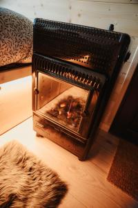 an open oven with a fire in it on the floor at Homnest - Loge insolite au coeur d'un ranch - Balade à cheval in Espinasse-Vozelle