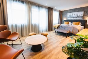 Una habitación de hotel con una cama, una mesa y sillas. en Centrum Hotel, en Akureyri