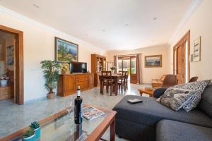 a living room with a couch and a table at Your Island Villa Son Serra in Son Serra de Marina