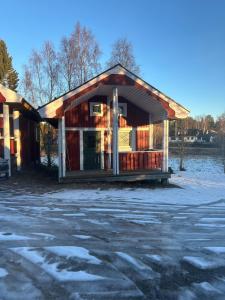 a building with a lot of snow on the ground at Marlens mysiga B&B in Pålänge