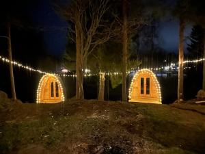 a house lit up at night with lights at Marlens mysiga B&B in Pålänge +5 photos