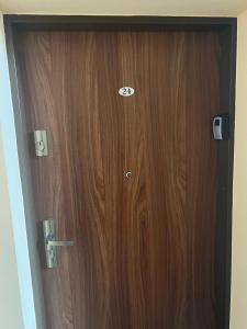 a wooden door with the number on it at Apartament Zacisze in Kalisz