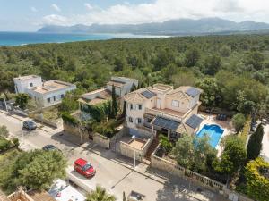 an aerial view of a house with the ocean in the background at Your Island Villa Son Serra in Son Serra de Marina