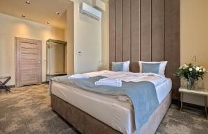 a bedroom with a large bed in a room at Oysters & Bubbles Gastro Rooms Rynek Square in Poznań +46 photos