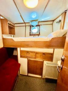 a small room with a bed and a sink at Lofoten Cruise & Hotel in Svolvær