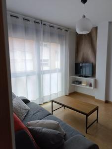 a living room with a couch and a coffee table at Apartamento Acogedor in Vinaròs