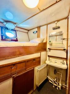 a small room with a bed and a sink at Lofoten Cruise & Hotel in Svolvær