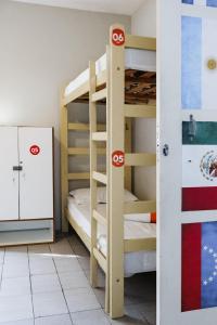 a bunk bed room with two bunk beds and a door at Pup Hostel SC in Florianópolis