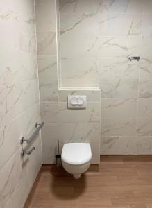 a bathroom with a white toilet and a mirror at Zenao Appart'hôtels Alfortville in Alfortville +13 photos