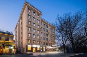 a large building in a city at night at Atour Hotel Beijing Nanluoguxiang Beixinqiao Subway Station in Beijing