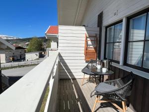 a balcony with two chairs and a table on it at Åre Stay- Åregårdarna 426 in Åre