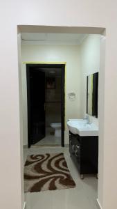 a bathroom with a sink and a toilet at Zayed chalet for families in Al Khīrān
