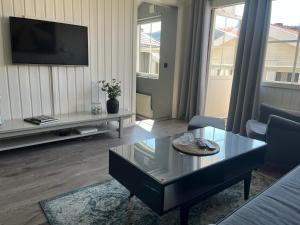 a living room with a coffee table and a tv at Åre Stay- Åregårdarna 426 in Åre