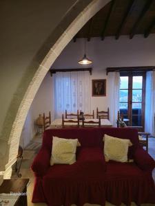 a bedroom with a red couch in a room at Lοfou-Queen in Lofou +21 photos
