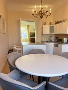 a kitchen with a white table and chairs at Altstadt Elegance in Graz Ostbahnhof
