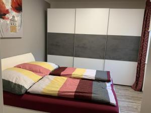 a bedroom with a bed with a colorful blanket at Machold in Nordhausen