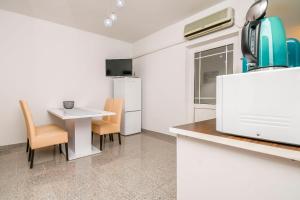 a kitchen with a small table and chairs in a room at Apartments and Room Napoli in Bol +58 photos