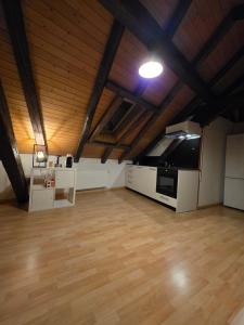 a large room with wooden ceilings and wooden floors at Petit studio centre ville in Montreux