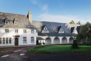 a large white building with a gray roof at Gite en Brocéliande avec vue in Néant-sur-Yvel
