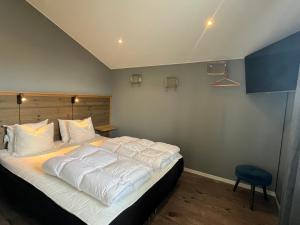 a bedroom with a large bed with white sheets at Åre Stay- Åregårdarna 426 in Åre