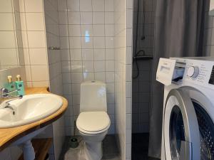 a bathroom with a toilet and a washing machine at Åre Stay- Åregårdarna 426 in Åre +11 photos