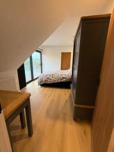 a bedroom with a bed and a television in a room at The Silvan Lodge, Peace, Privacy, and Pure calm  +39 photos