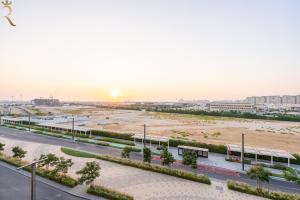 an aerial view of a road in a city at Bright 1BR with Balcony the Gate, Masdar City in Abu Dhabi