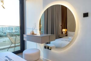 a hotel room with a mirror and a bed at Bright 1BR with Balcony the Gate, Masdar City in Abu Dhabi +32 photos