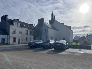 a group of cars parked in a parking lot at Le Petit Cocon de Pleyben in Pleyben