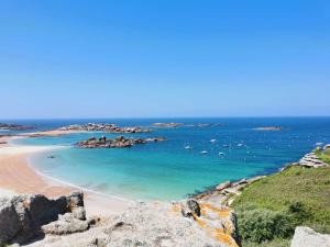 a beach with a bunch of boats in the water at Appartement Trégastel: Vue mer, Parking privé, Petit chien admis. - FR-1-542-5 in Trégastel +7 photos