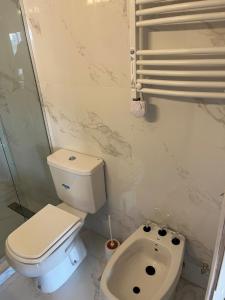 a bathroom with a toilet and a sink at Stuart's Apartment in Mar del Plata +12 photos