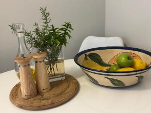 a bowl of fruit next to a bowl of fruit at De Eike in Stellenbosch +10 photos