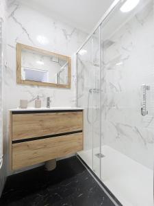 a bathroom with a sink and a shower at Mariani Place to Be in St Etienne in Saint-Étienne