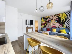 a living room with a large painting of a woman at Mariani Place to Be in St Etienne in Saint-Étienne