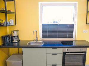 a kitchen with a sink and a window at Apartment Schnakenberg by Interhome in Ober Ochtenhausen