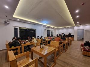 a group of people sitting at tables in a restaurant at Nomad Luxe Vista Dalhousie in Dalhousie