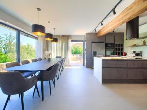 a kitchen and dining room with a table and chairs at Villa Miryam by Interhome in Vrh +44 photos