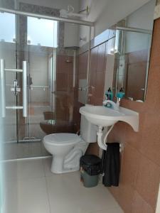 a bathroom with a toilet and a sink and a shower at Kitnet Boa Vista in Sete Lagoas
