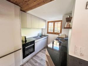 a small kitchen with a sink and a stove at Apartment Casa Foppa by Interhome in Somvix