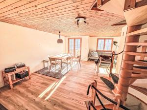 a living room with a dining room table and chairs at Apartment Casa Foppa by Interhome in Somvix
