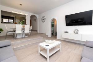 a living room with a couch and a table at Cristian Sur Luxury 2 Bedroom Apartment in Los Cristianos