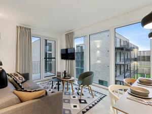 a living room with a couch and a table at Apartment Imort by Interhome in Lembruch