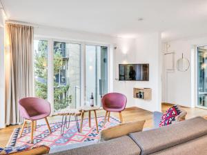 a living room with a couch and chairs and a table at Apartment Seeidyll by Interhome in Lembruch +22 photos