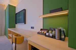 an office with a counter with a desk with a phone at TMG Hotel Tebet, Marclan Collection in Jakarta