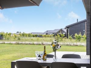 a table with a bottle of wine and flowers on it at Holiday Home Emelina - 300m from the sea by Interhome in Rude