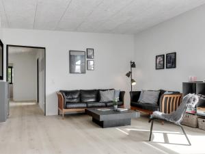 a living room with a couch and a table at Holiday Home Emelina - 300m from the sea by Interhome in Rude