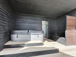 a room with a bath tub and a bed at Holiday Home Emelina - 300m from the sea by Interhome in Rude