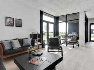 a living room with a couch and a table at Holiday Home Emelina - 300m from the sea by Interhome in Rude +15 photos