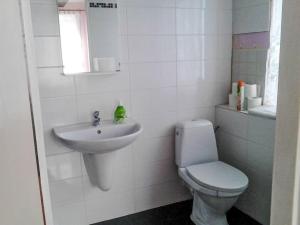 a white bathroom with a toilet and a sink at Apartment Jiřetínská chaloupka by Interhome in Jiřetín pod Jedlovou