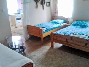 a bedroom with two beds and a table in it at Apartment Jiřetínská chaloupka by Interhome in Jiřetín pod Jedlovou